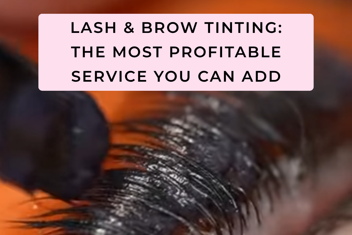 Close-up of lashes lifted on a rod being tinted black with a flat-tip brush
